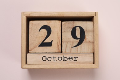 Photo of International Psoriasis Day - 29th of October. Block calendar on beige background, top view