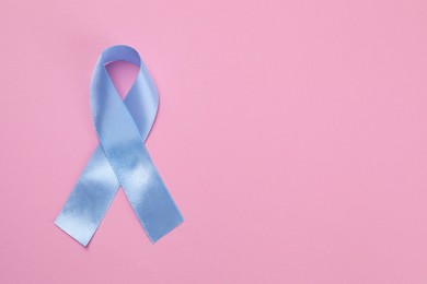 International Psoriasis Day. Ribbon as symbol of support on pink background, top view. Space for text