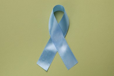 International Psoriasis Day. Ribbon as symbol of support on green background, top view