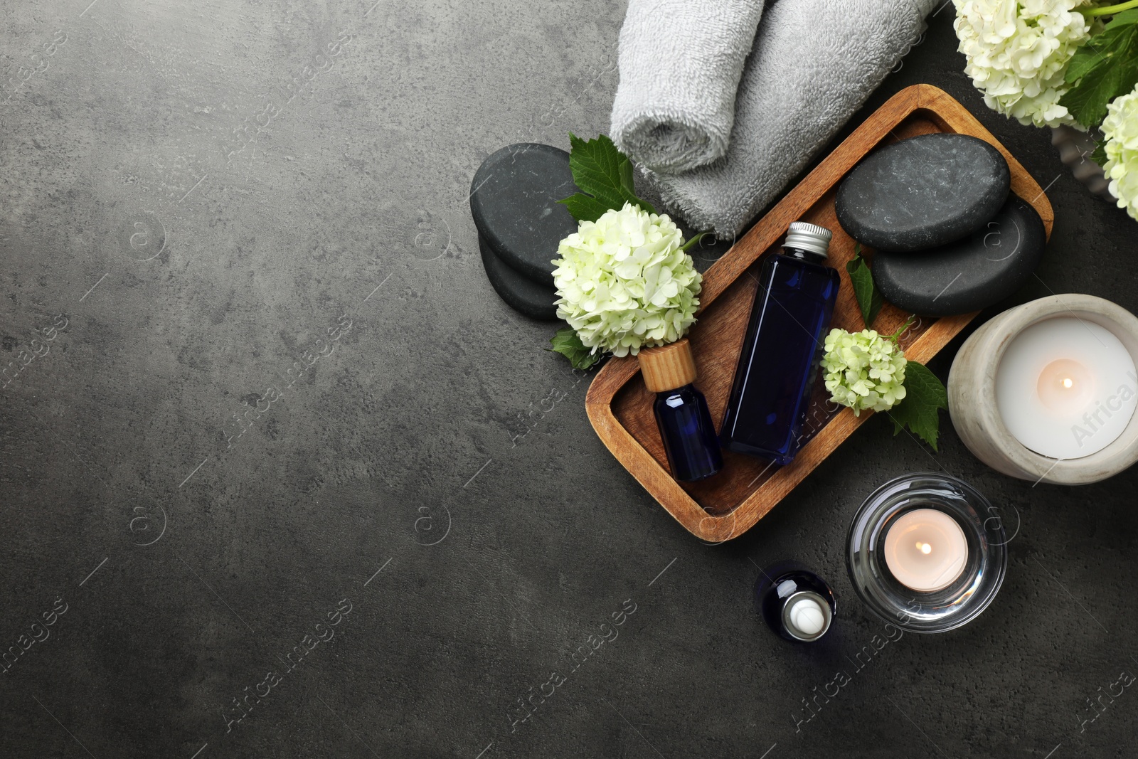 Photo of Flat lay composition with spa products on gray table, space for text