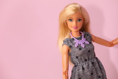 Photo of Mykolaiv, Ukraine - September 4, 2023: Beautiful Barbie doll wearing necklace on violet background, space for text