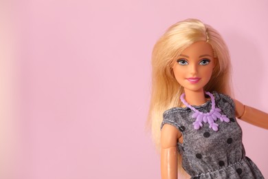 Photo of Mykolaiv, Ukraine - September 4, 2023: Beautiful Barbie doll wearing necklace on violet background, space for text