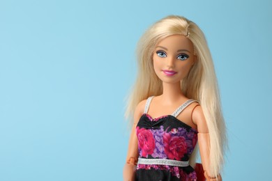 Photo of Mykolaiv, Ukraine - September 4, 2023: Beautiful Barbie doll on light blue background, space for text