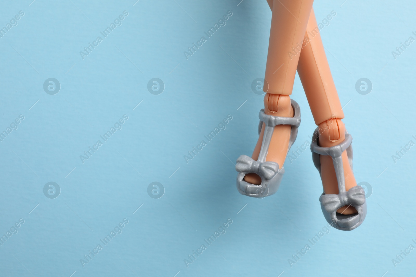 Photo of Mykolaiv, Ukraine - September 4, 2023: Barbie doll wearing beautiful heels on light blue background, closeup. Space for text