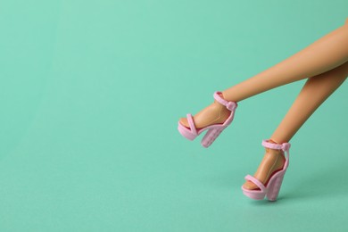 Photo of Mykolaiv, Ukraine - September 2, 2023: Barbie doll wearing beautiful heels on turquoise background, closeup with space for text