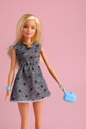 Photo of Mykolaiv, Ukraine - September 2, 2023: Beautiful Barbie doll with bag on pale pink background