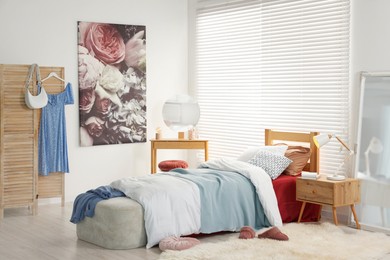 Teen's room interior with modern furniture and beautiful picture on wall