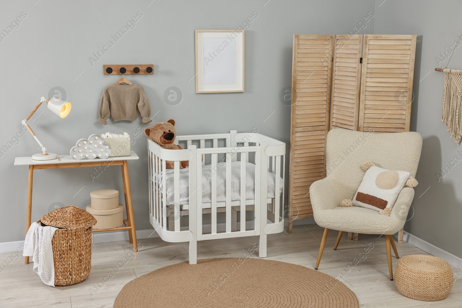 Photo of Newborn baby room interior with stylish furniture and comfortable crib