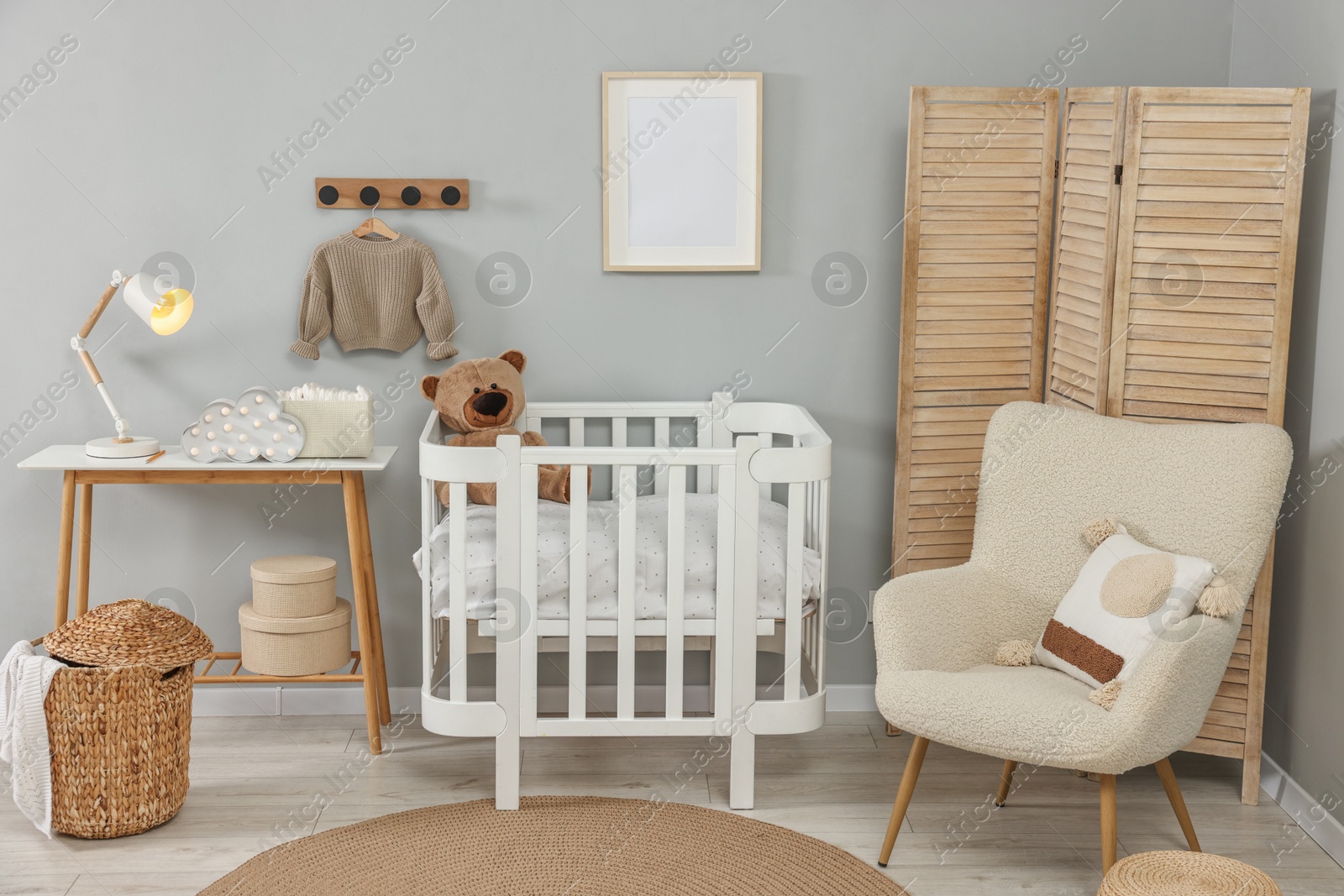 Photo of Newborn baby room interior with stylish furniture and comfortable crib