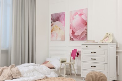 Photo of Cute child's room interior with modern furniture and beautiful pictures of on wall