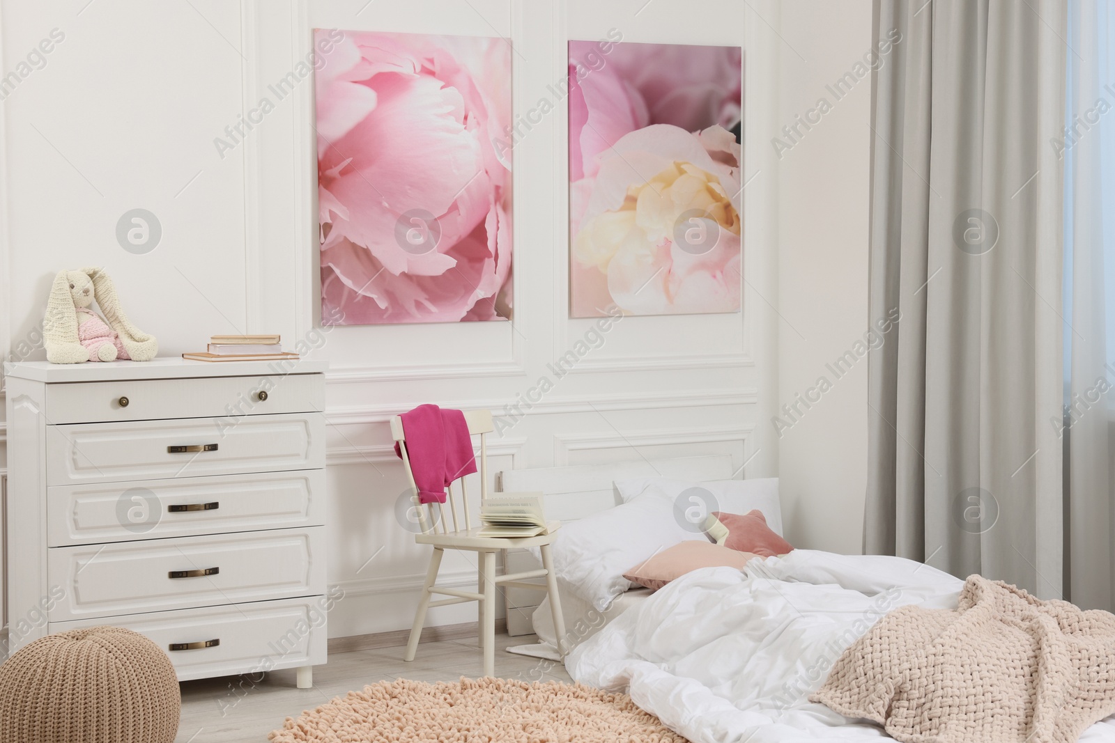 Photo of Cute child's room interior with modern furniture and beautiful pictures of on wall