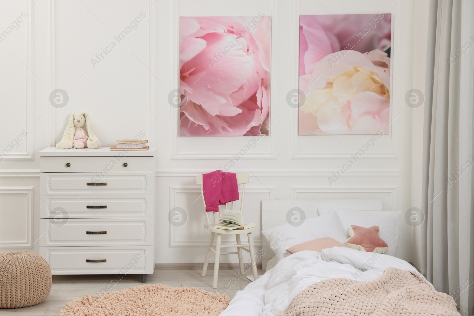 Photo of Cute child's room interior with modern furniture and beautiful pictures of on wall