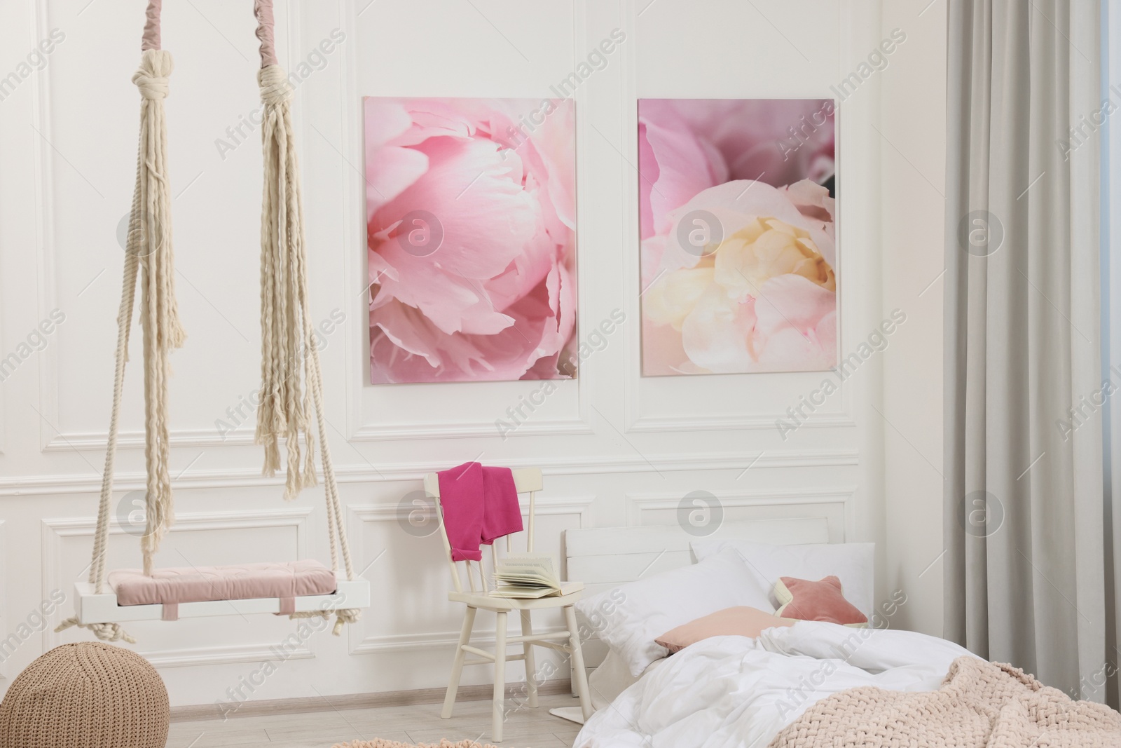 Photo of Cute child's room interior with swing and beautiful pictures of on wall