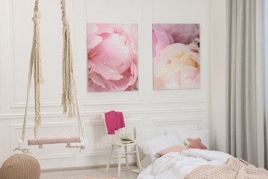 Photo of Cute child's room interior with swing and beautiful pictures of on wall