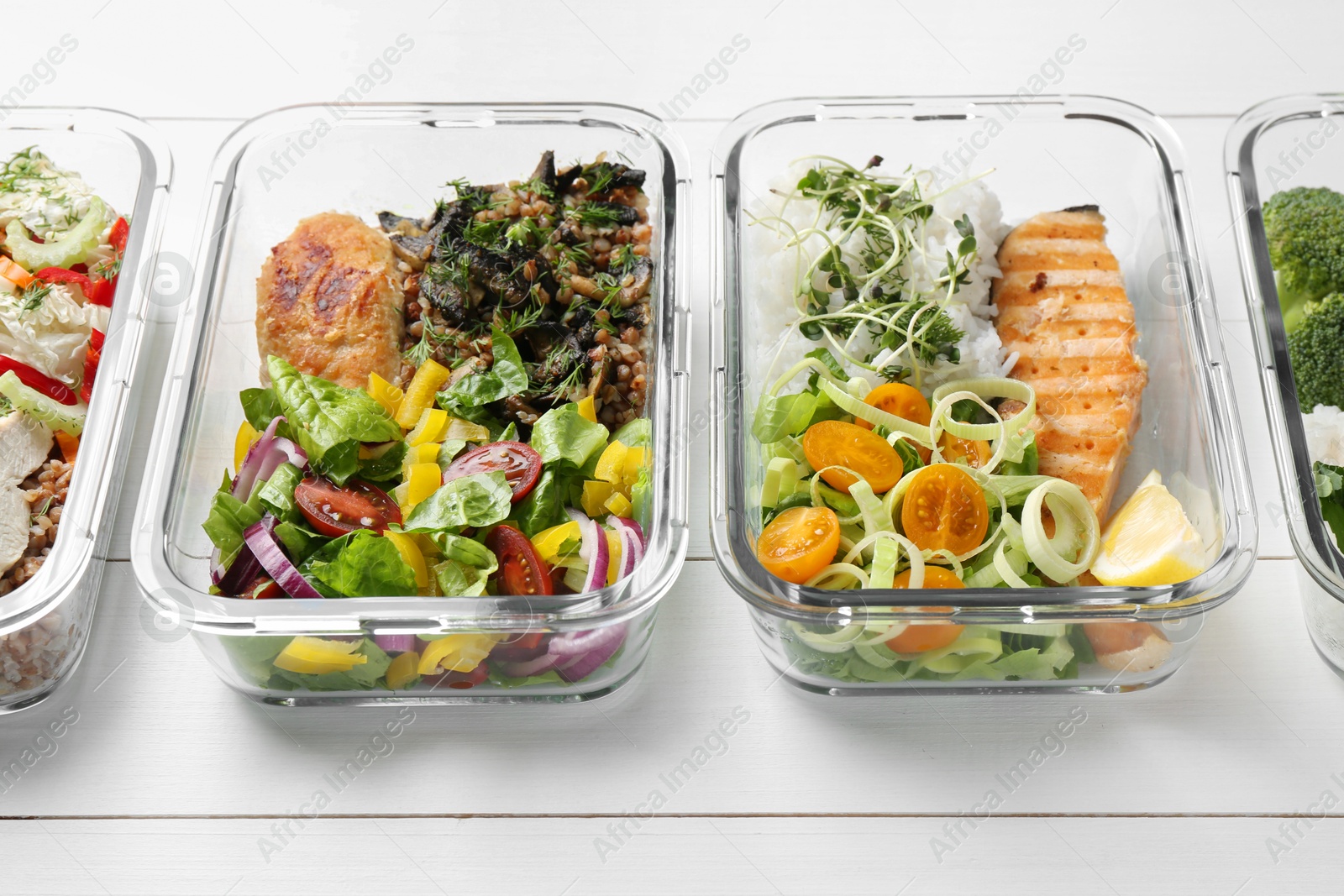 Photo of Healthy meal. Containers with different products on white wooden table