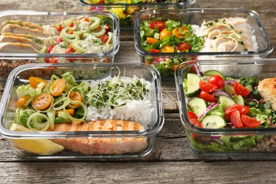 Photo of Healthy meal. Containers with different products on wooden table