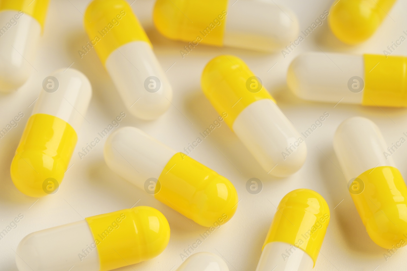 Photo of Many antibiotic pills on white background, closeup