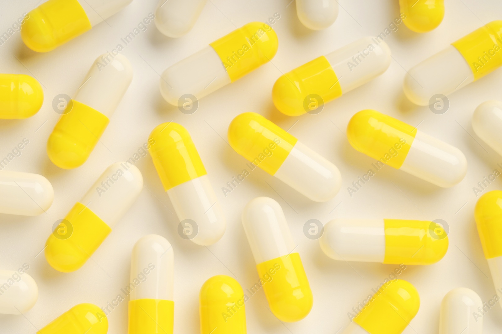 Photo of Many antibiotic pills on white background, top view