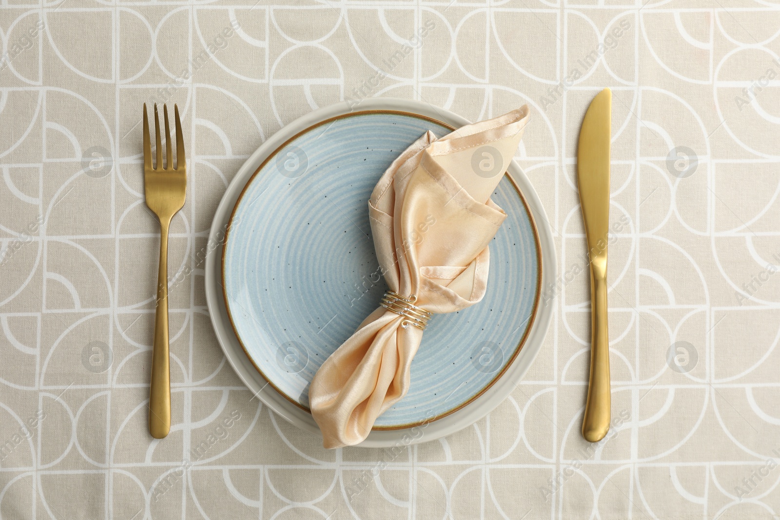 Photo of Stylish setting with cutlery, plates and napkin on table, top view