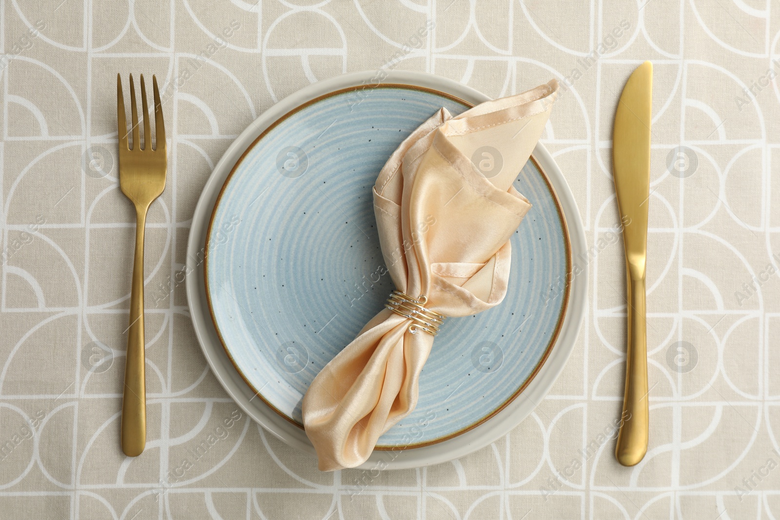 Photo of Stylish setting with cutlery, plates and napkin on table, top view