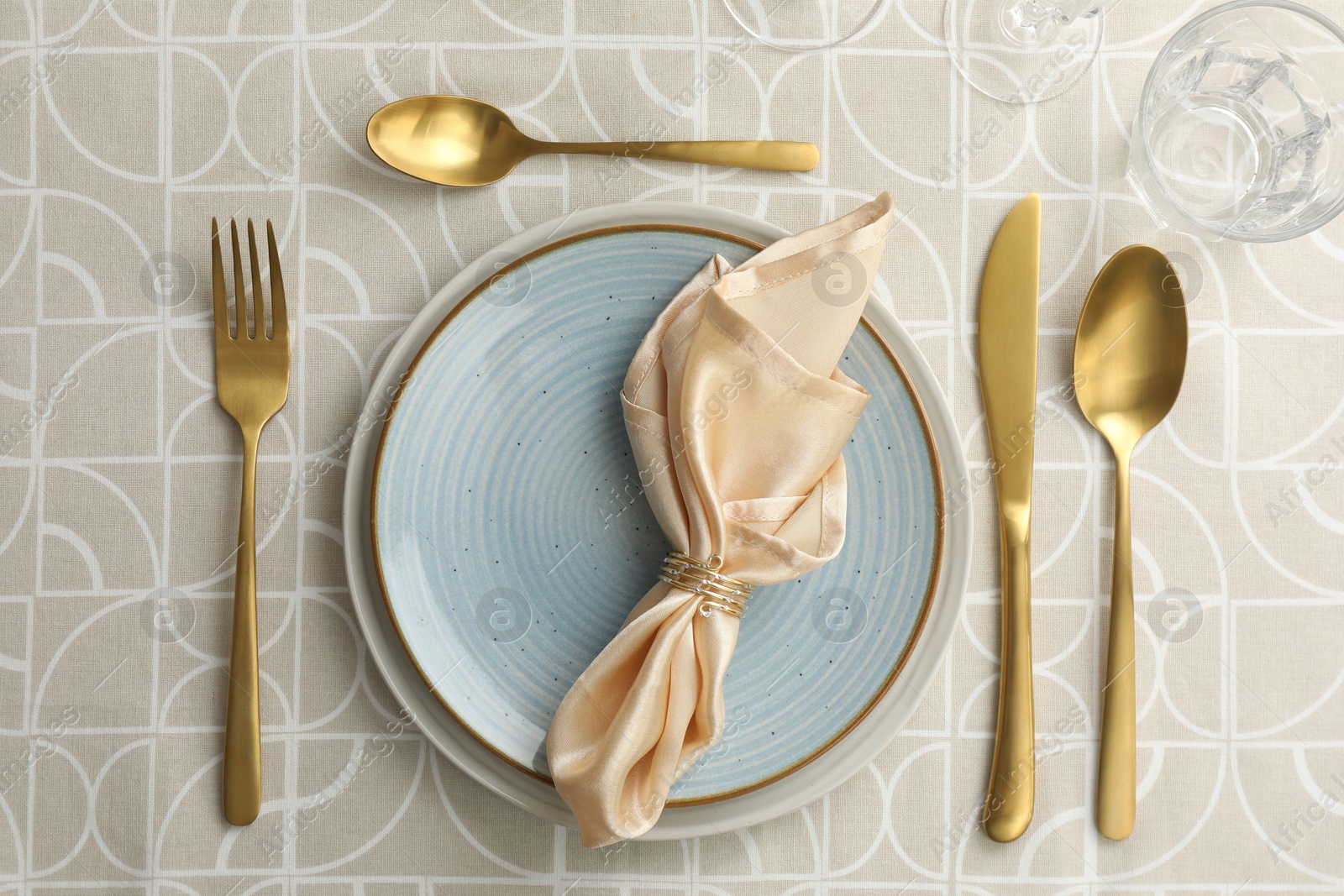 Photo of Stylish setting with cutlery, plates, napkin and glass on table, flat lay