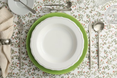 Photo of Stylish setting with cutlery, plates, napkin and glasses on table, flat lay