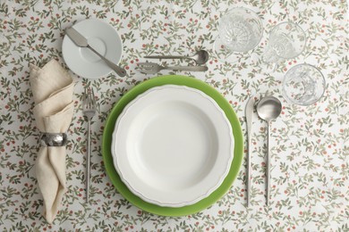 Photo of Stylish setting with cutlery, plates, napkin and glasses on table, flat lay