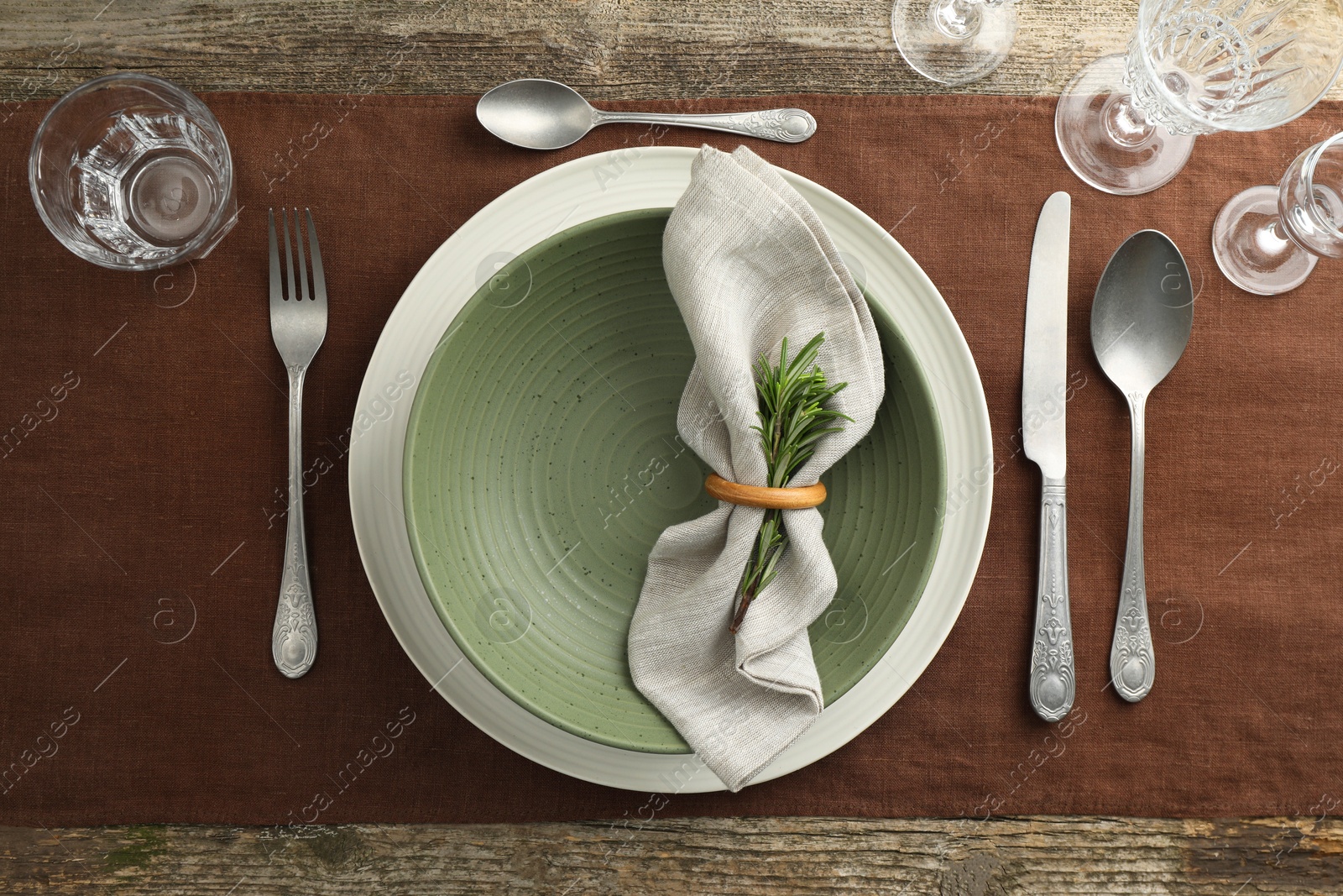 Photo of Stylish setting with cutlery, glasses, plate and bowl on wooden table, flat lay