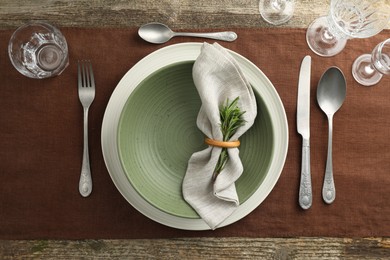 Stylish setting with cutlery, glasses, plate and bowl on wooden table, flat lay