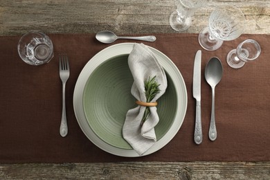 Photo of Stylish setting with cutlery, glasses, plate and bowl on wooden table, flat lay