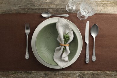 Photo of Stylish setting with cutlery, glasses, plate and bowl on wooden table, flat lay