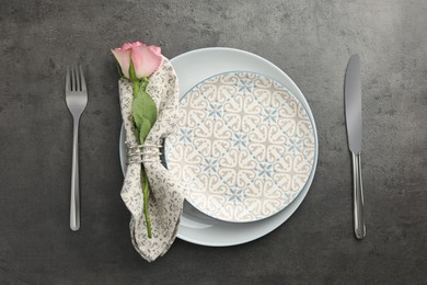 Photo of Stylish setting with cutlery and plates on black table, flat lay