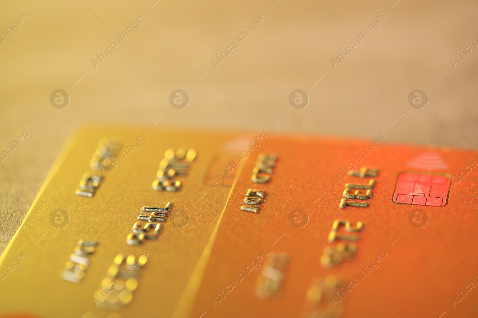 Photo of Two credit cards on blurred background, macro view
