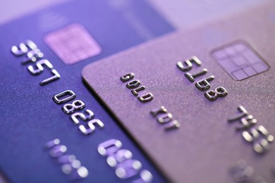 Photo of Plastic credit cards on table, macro view. Color toned