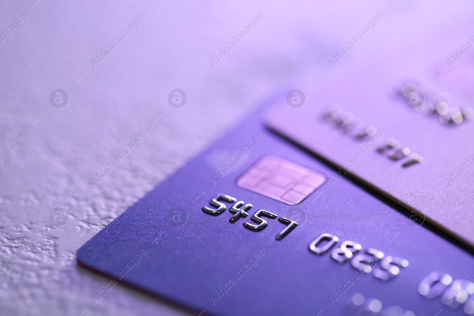 Photo of Plastic credit cards on table, closeup view. Color toned