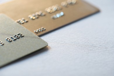 Two credit cards on light background, closeup