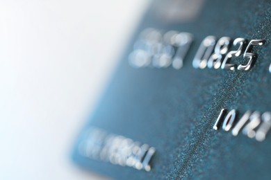 Photo of One credit card on light background, macro view