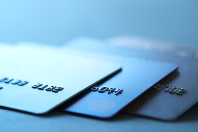 Photo of Many credit cards on blurred background, closeup