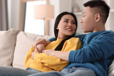 Happy young couple on sofa at home