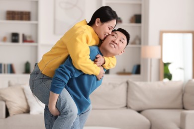 Photo of Happy couple spending time together at home, space for text