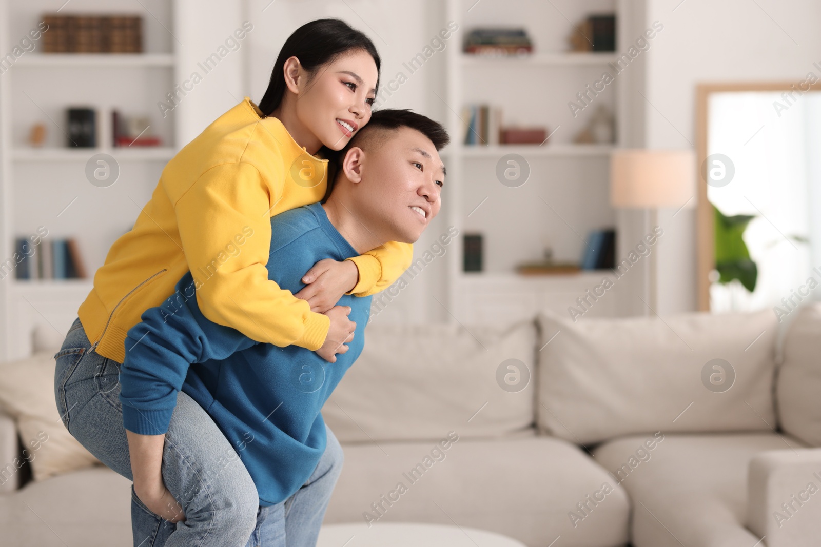 Photo of Happy couple spending time together at home, space for text