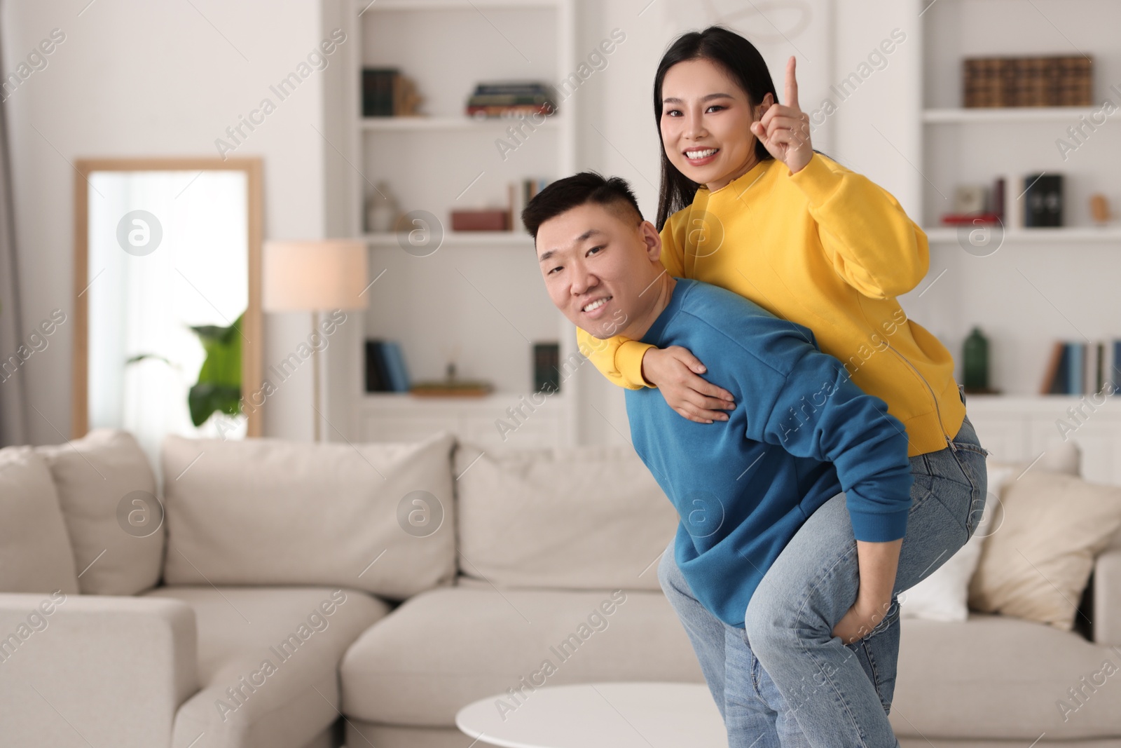 Photo of Happy couple spending time together at home, space for text