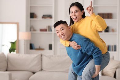 Photo of Happy couple spending time together at home, space for text