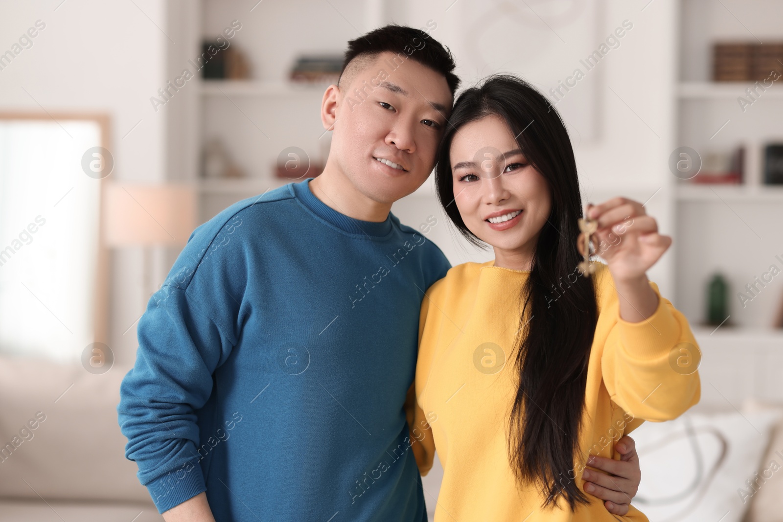 Photo of Happy couple with key in their new apartment