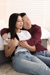 Photo of Lovely young couple on floor at home