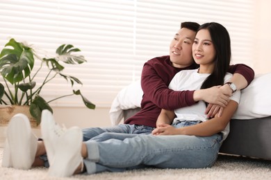 Photo of Lovely young couple on floor at home