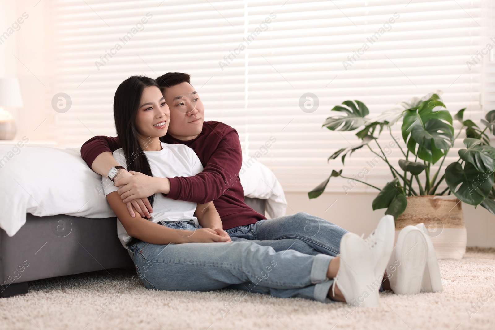 Photo of Lovely young couple on floor at home
