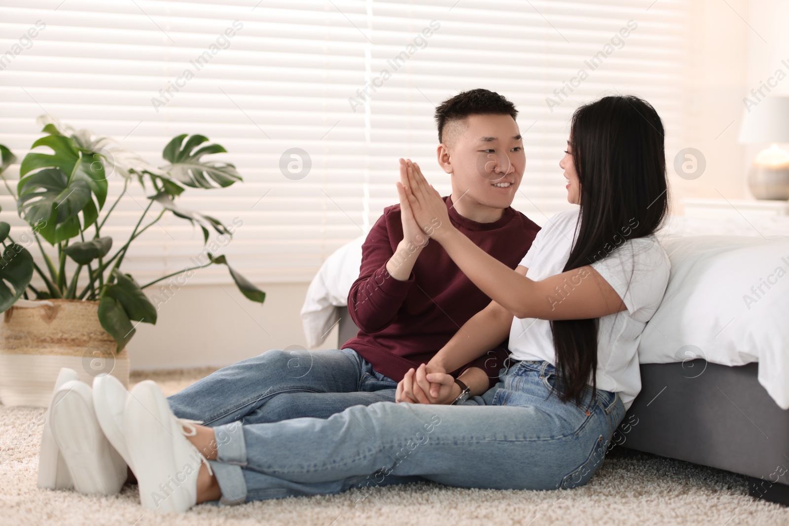 Photo of Lovely young couple on floor at home