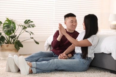 Lovely young couple on floor at home