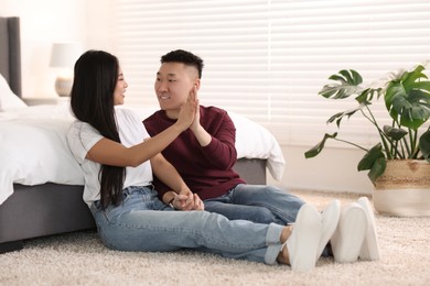 Photo of Lovely young couple on floor at home